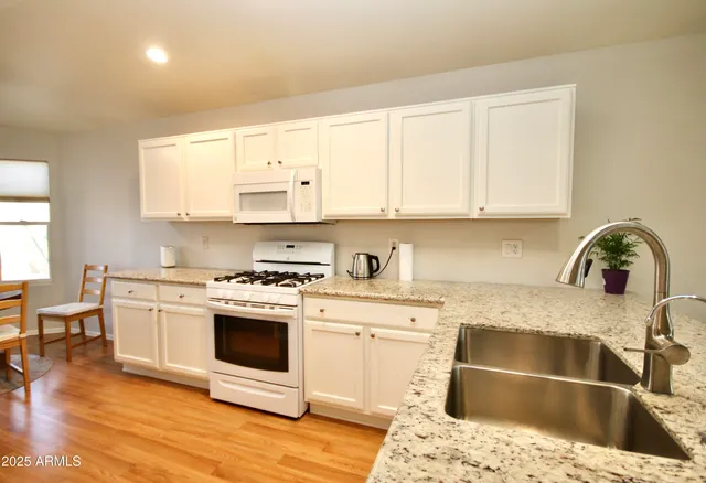 a kitchen with a sink stove and cabinets
