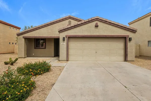 a front view of a house with a yard and garage