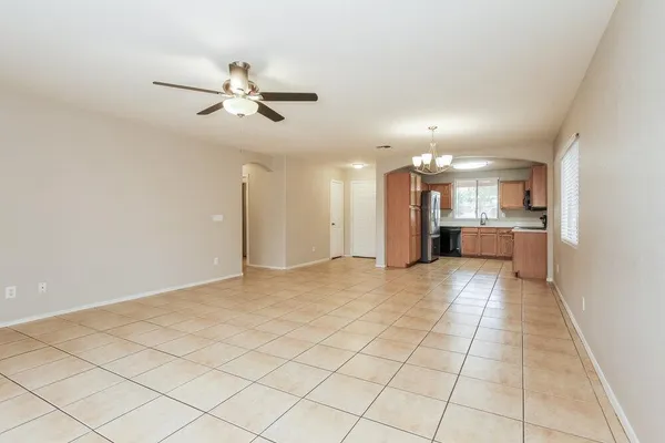a view of a kitchen with a sink and a refrigerator