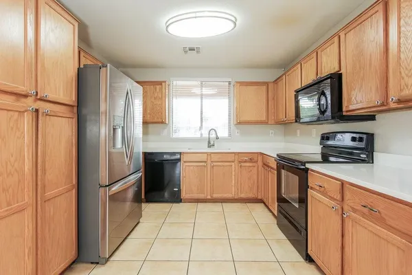 a kitchen with stainless steel appliances granite countertop a refrigerator sink and cabinets