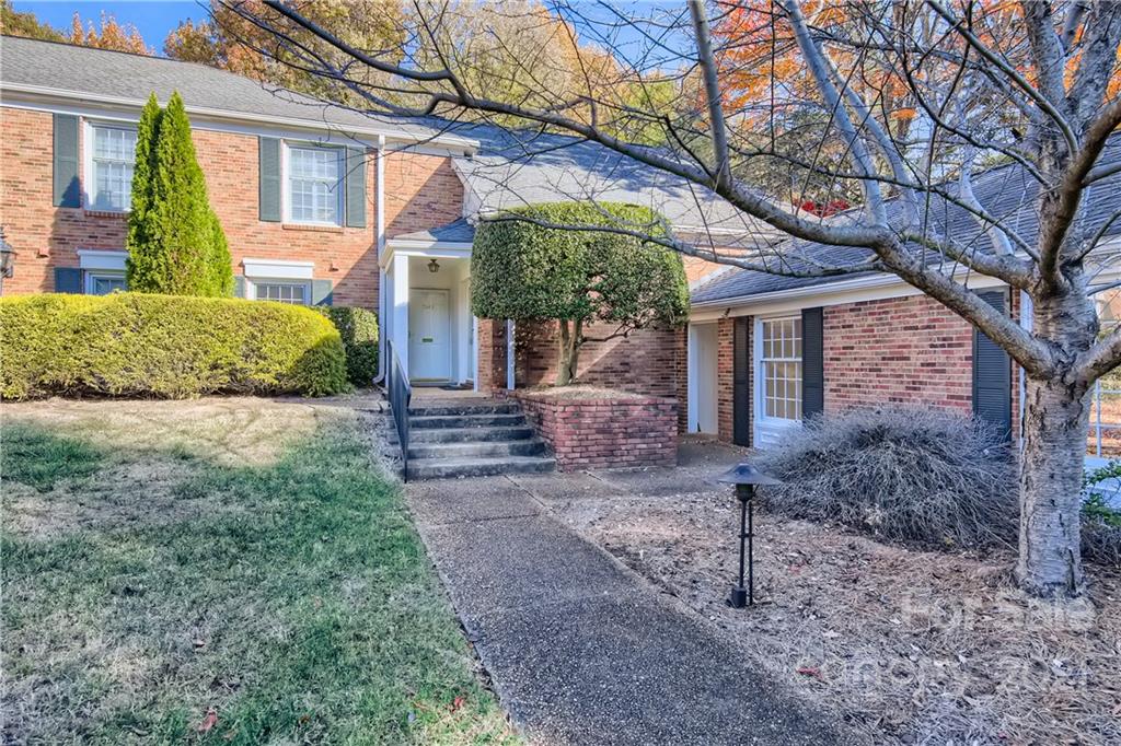 7040 Quail Hill Road Charlotte, NC 28210 - Photo 2 of 33 a front view of a house with garden