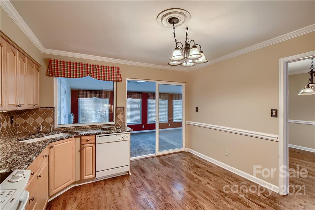 7040 Quail Hill Road Charlotte, NC 28210 - Photo 11 of 33 a view of a kitchen with a sink wooden floor and staircase