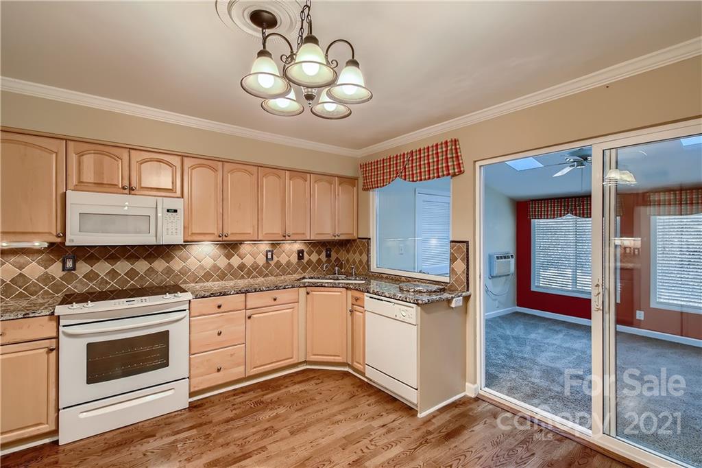 7040 Quail Hill Road Charlotte, NC 28210 - Photo 12 of 33 a kitchen with stainless steel appliances granite countertop a stove and cabinets
