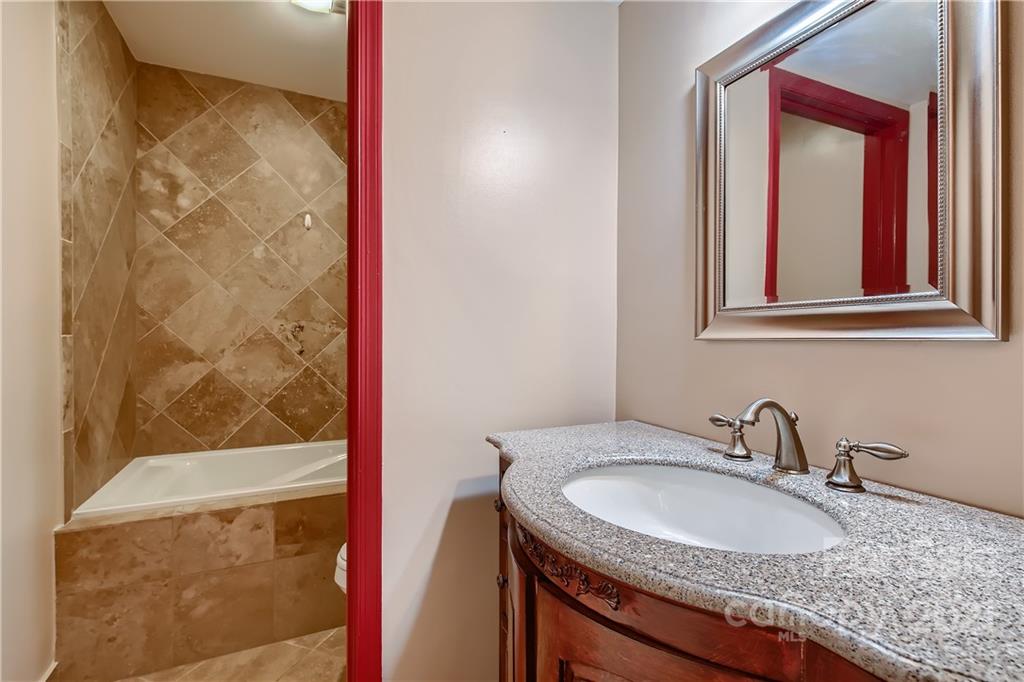 7040 Quail Hill Road Charlotte, NC 28210 - Photo 18 of 33 a bathroom with a granite countertop sink and a mirror