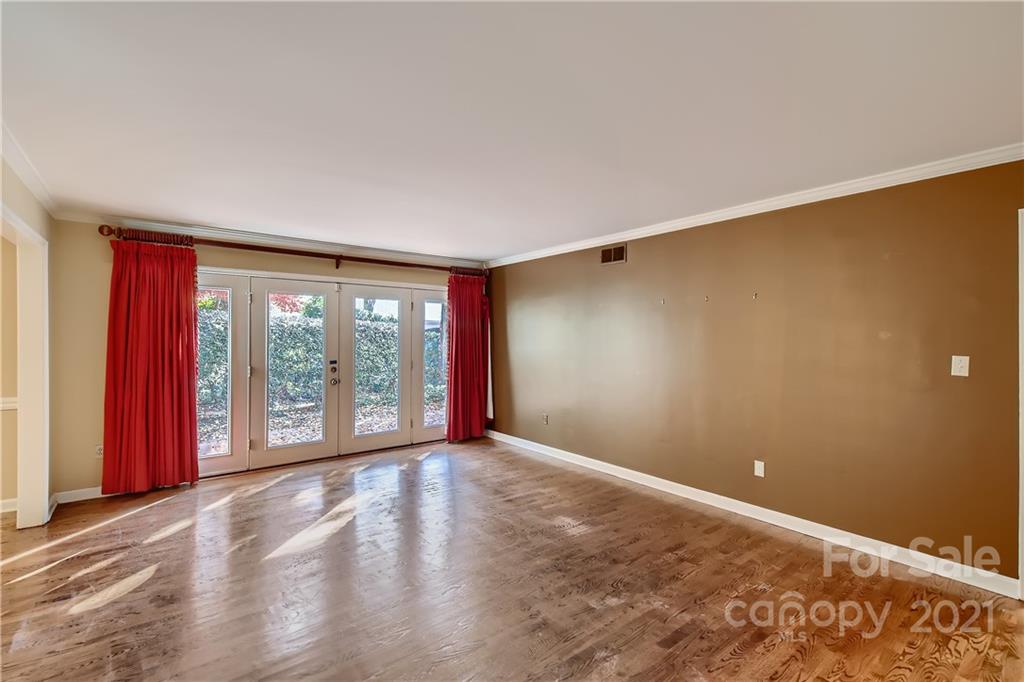 7040 Quail Hill Road Charlotte, NC 28210 - Photo 7 of 33 a view of an empty room with wooden floor and a window
