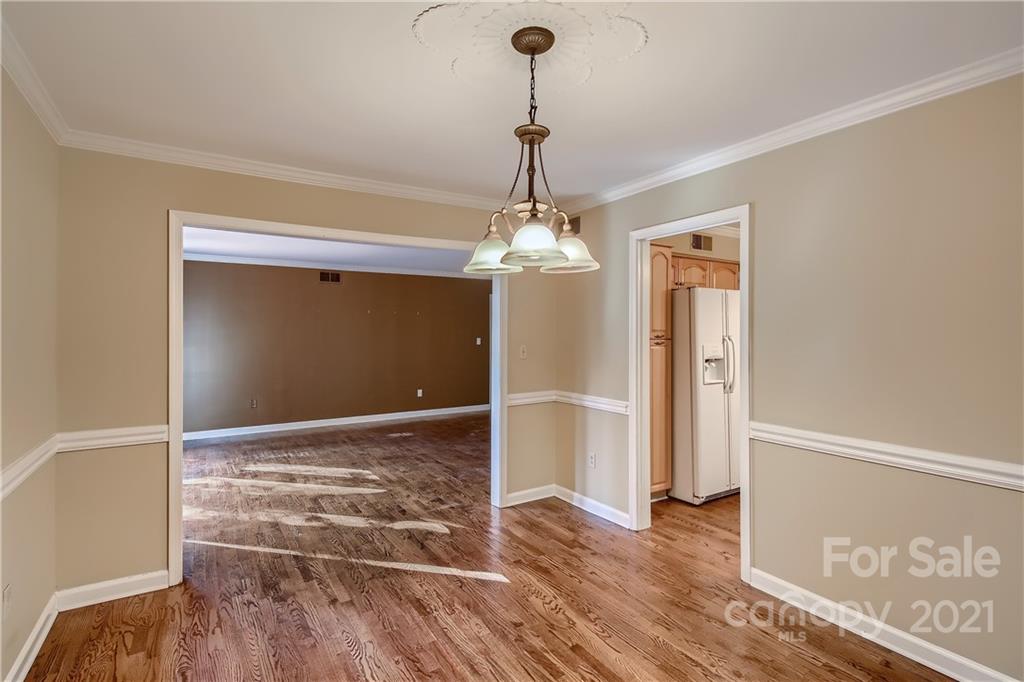 7040 Quail Hill Road Charlotte, NC 28210 - Photo 8 of 33 a view of a livingroom with wooden floor staircase and a kitchen space