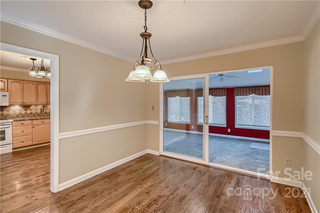 7040 Quail Hill Road Charlotte, NC 28210 - Photo 10 of 33 a view of a room with wooden floor kitchen view and a window