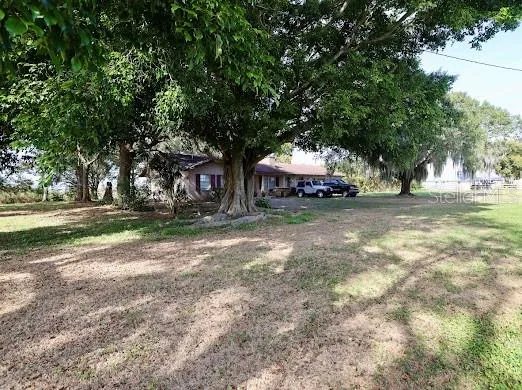 a view of a house with a yard and garage