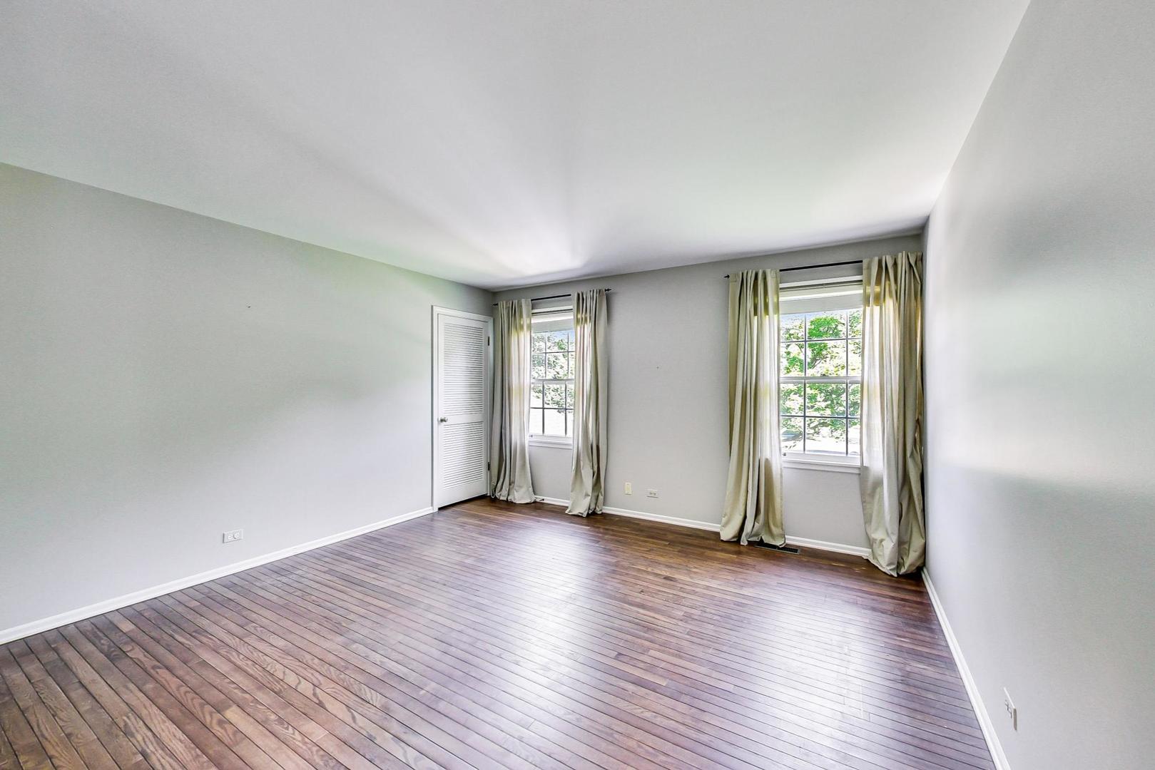 2441 Shannon Road Northbrook, IL 60062 - Photo 16 of 26 an empty room with wooden floor and windows