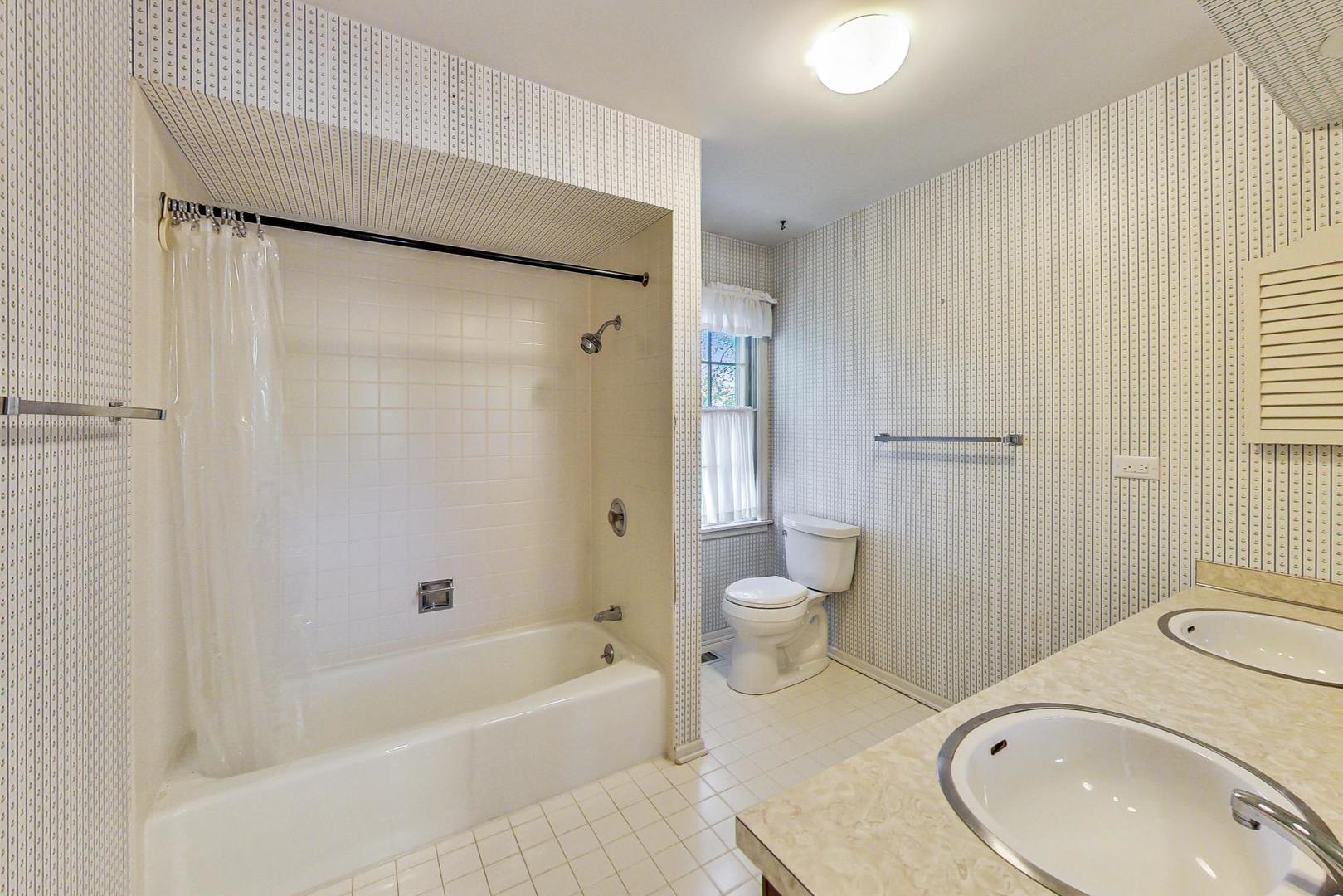 2441 Shannon Road Northbrook, IL 60062 - Photo 18 of 26 a bathroom with a sink a toilet and shower