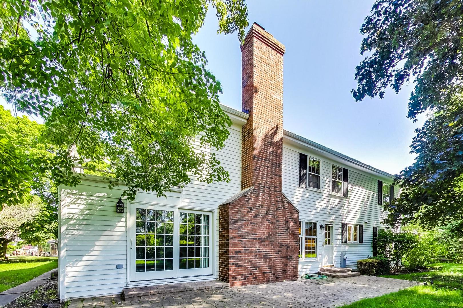 2441 Shannon Road Northbrook, IL 60062 - Photo 2 of 26 a front view of a house with a garden