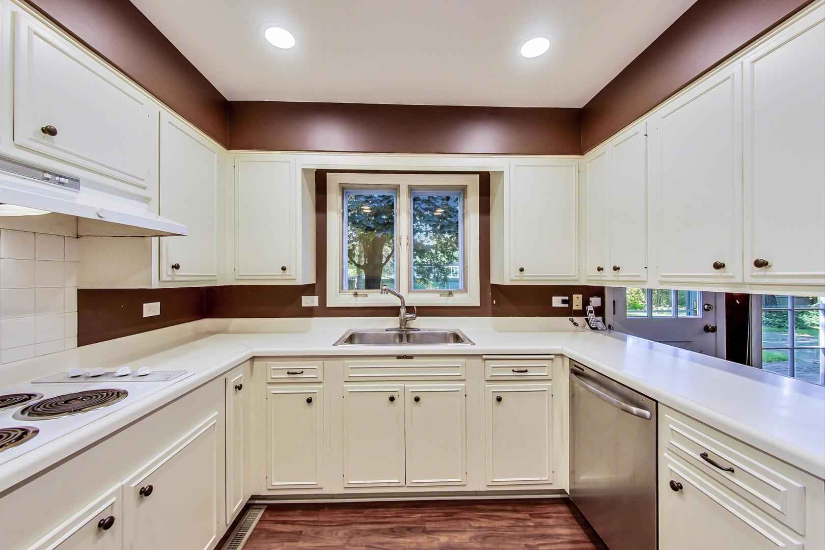 2441 Shannon Road Northbrook, IL 60062 - Photo 8 of 26 a kitchen with a sink stove and cabinets
