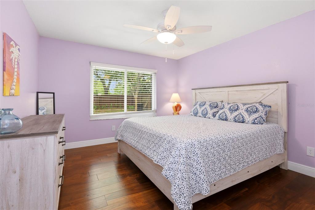 7432 Sparkling Lake Road Orlando, FL 32819 - Photo 27 of 54 a bed room with a bed and a couch