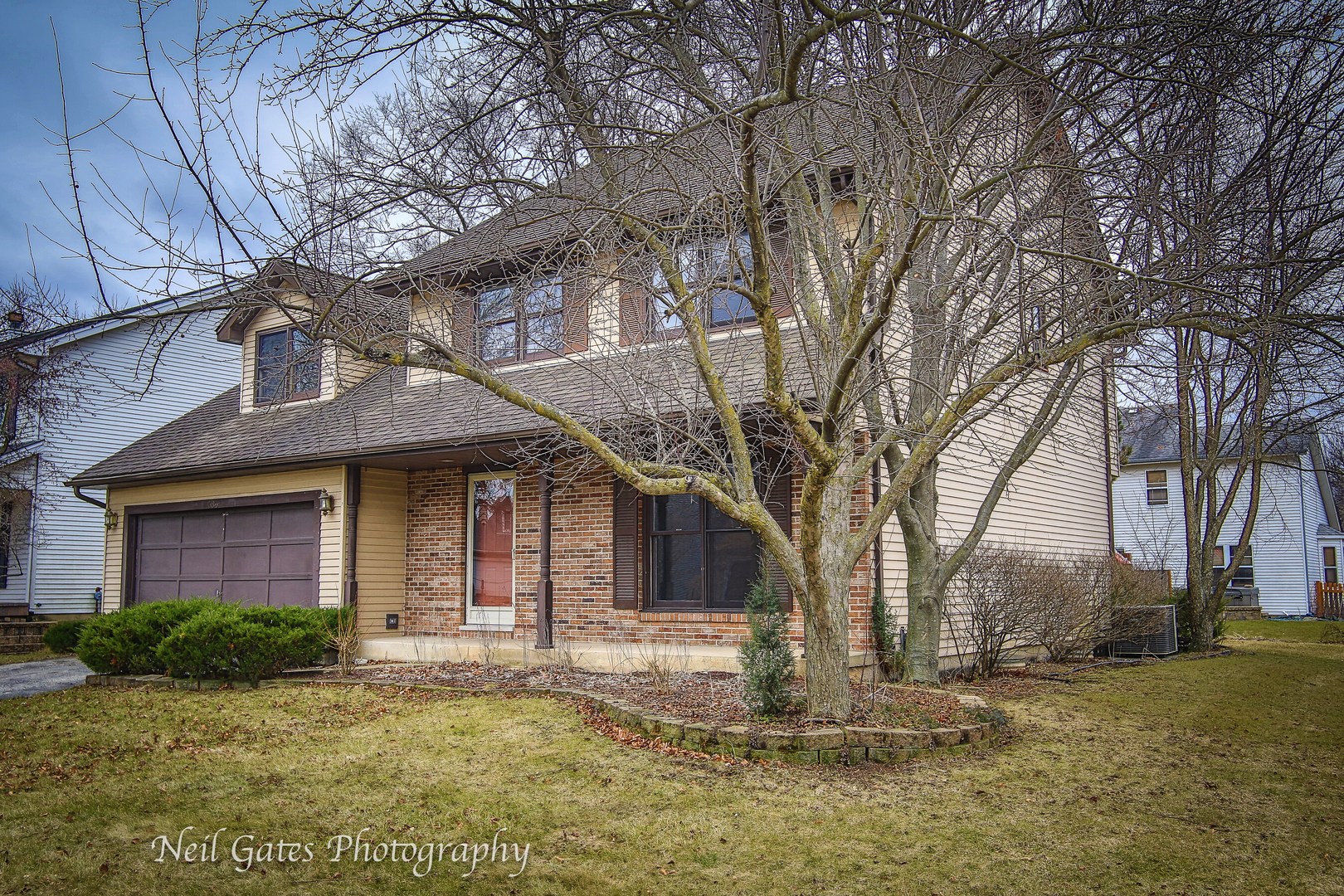 586 Roxbury Drive Naperville, IL 60565 - Photo 2 of 39 a brick house with trees in front of it