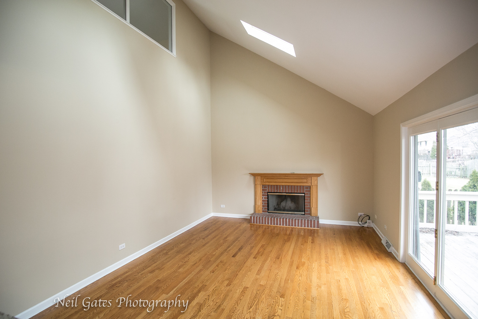 586 Roxbury Drive Naperville, IL 60565 - Photo 12 of 39 a view of empty room with wooden floor and fireplace