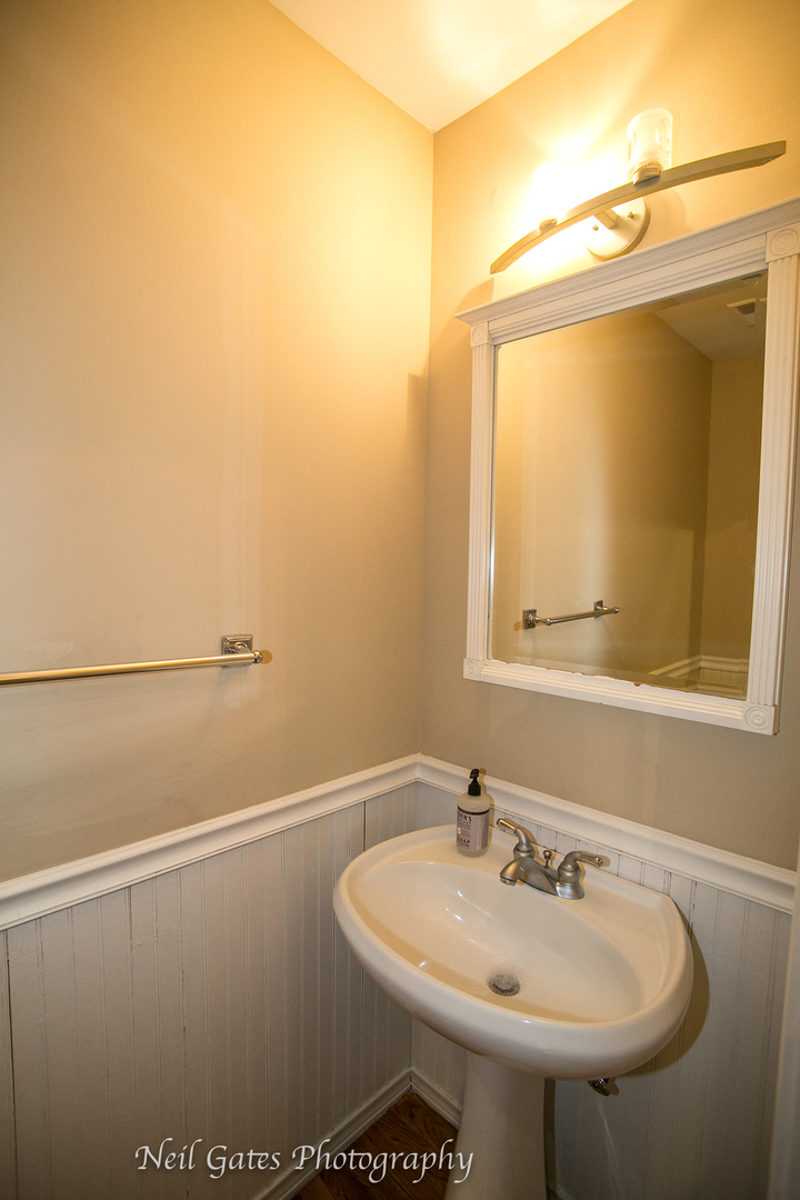 586 Roxbury Drive Naperville, IL 60565 - Photo 16 of 39 a bathroom with a sink and a mirror