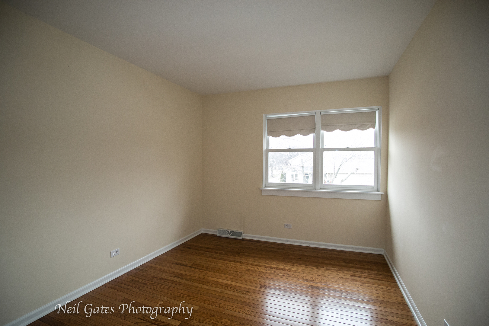 586 Roxbury Drive Naperville, IL 60565 - Photo 22 of 39 an empty room with wooden floor and windows