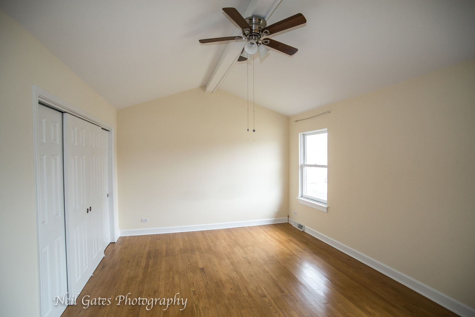 586 Roxbury Drive Naperville, IL 60565 - Photo 25 of 39 a view of empty room with wooden floor and fan