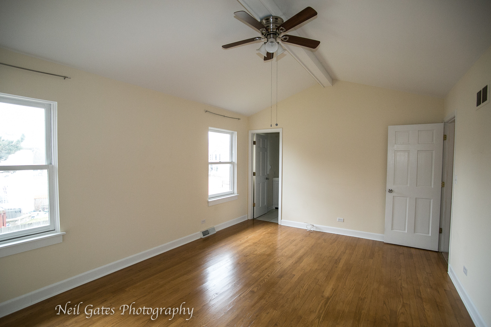 586 Roxbury Drive Naperville, IL 60565 - Photo 26 of 39 a view of empty room with wooden floor and fan
