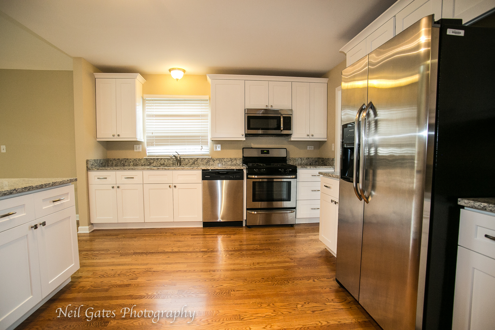 586 Roxbury Drive Naperville, IL 60565 - Photo 6 of 39 a kitchen with stainless steel appliances granite countertop a refrigerator a stove and a sink
