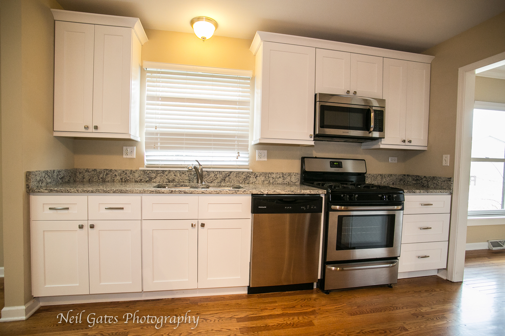 586 Roxbury Drive Naperville, IL 60565 - Photo 8 of 39 a kitchen with granite countertop white cabinets stainless steel appliances and sink