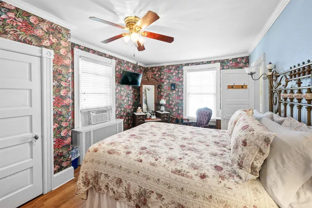 a bedroom with bed and a chandelier