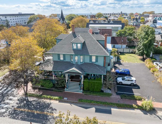 an aerial view of a house with a garden and lake view