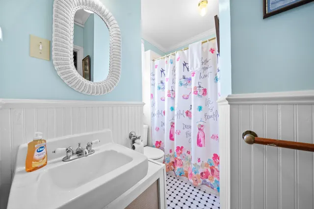 a bedroom with bed and a chandelier