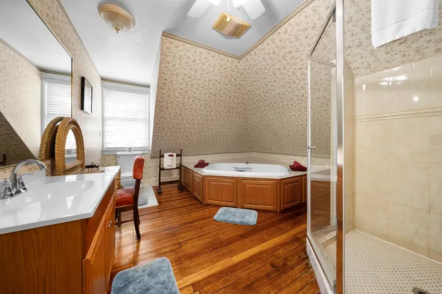 a bedroom with a bed couch and a window