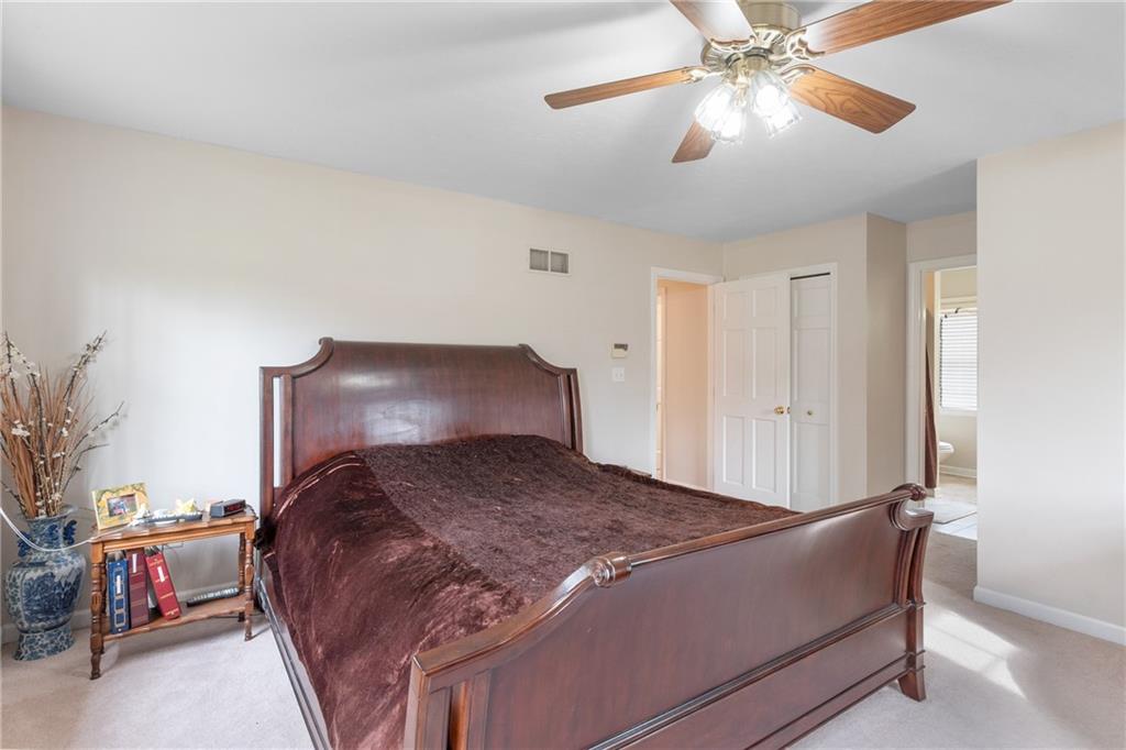 207 Oak Leaf Drive Mars, PA 16046 - Photo 17 of 40 a bedroom with a bed and a chandelier