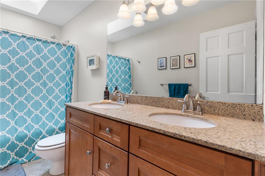 207 Oak Leaf Drive Mars, PA 16046 - Photo 22 of 40 a bathroom with a granite countertop double vanity sink mirror and toilet