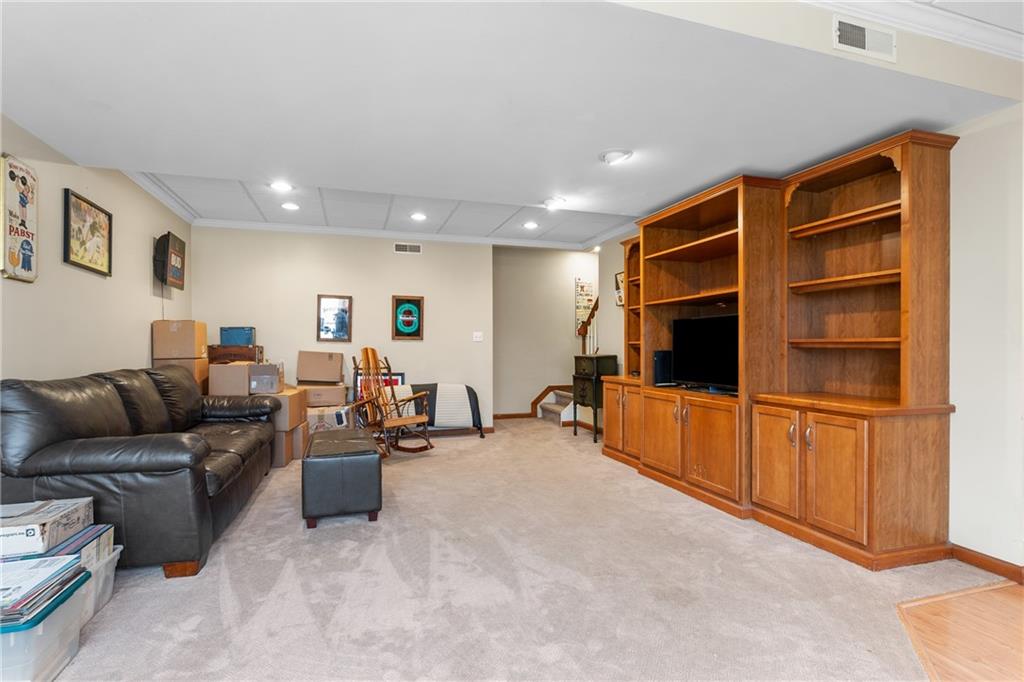 207 Oak Leaf Drive Mars, PA 16046 - Photo 30 of 40 a living room with furniture a flat screen tv and kitchen view