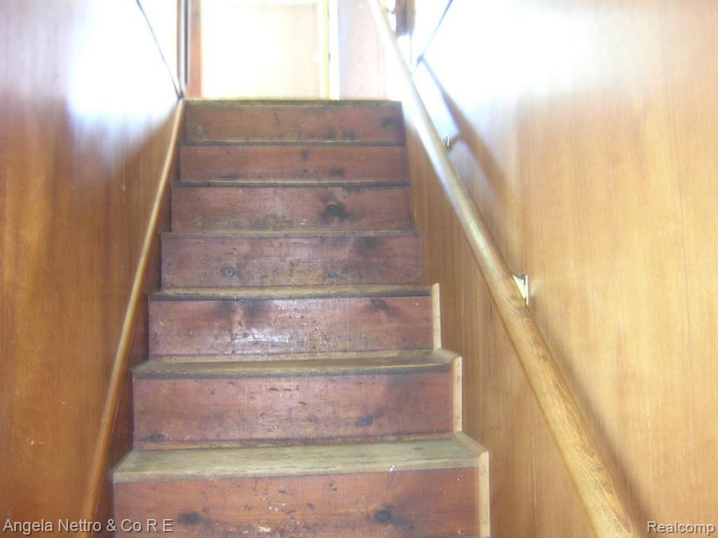 14299 Tuttle Hill Road Milan, MI 48160 - Photo 17 of 21 WOOD STAIRWAY TO UPPER LEVEL