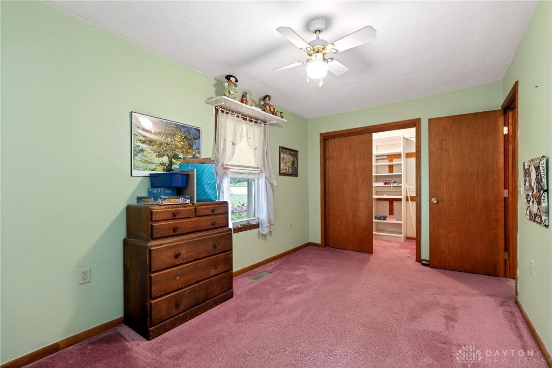 2470 Clark Run Road Xenia, OH 45385 - Photo 17 of 57 This cozy bedroom offers comfort and a well-organized closet space for optimal living.