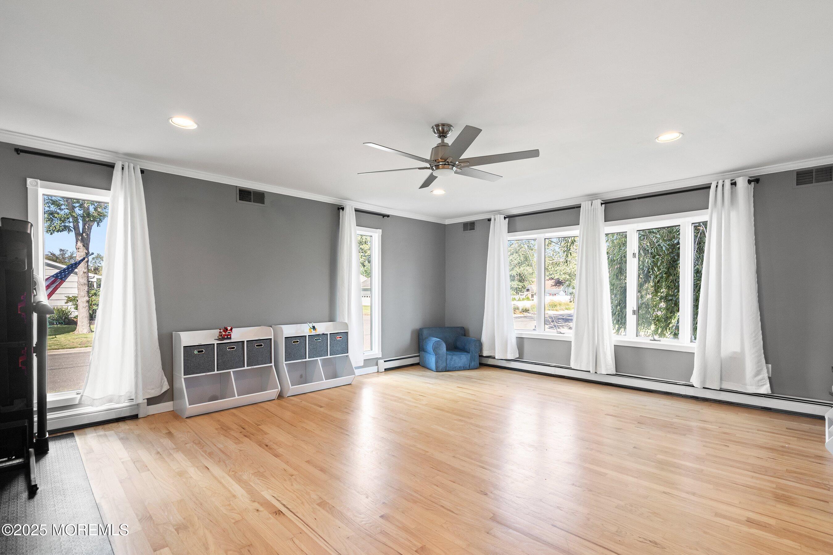 1615 Calamus Place Point Pleasant, NJ 08742 - Photo 11 of 62 a view of an empty room with a window and wooden floor