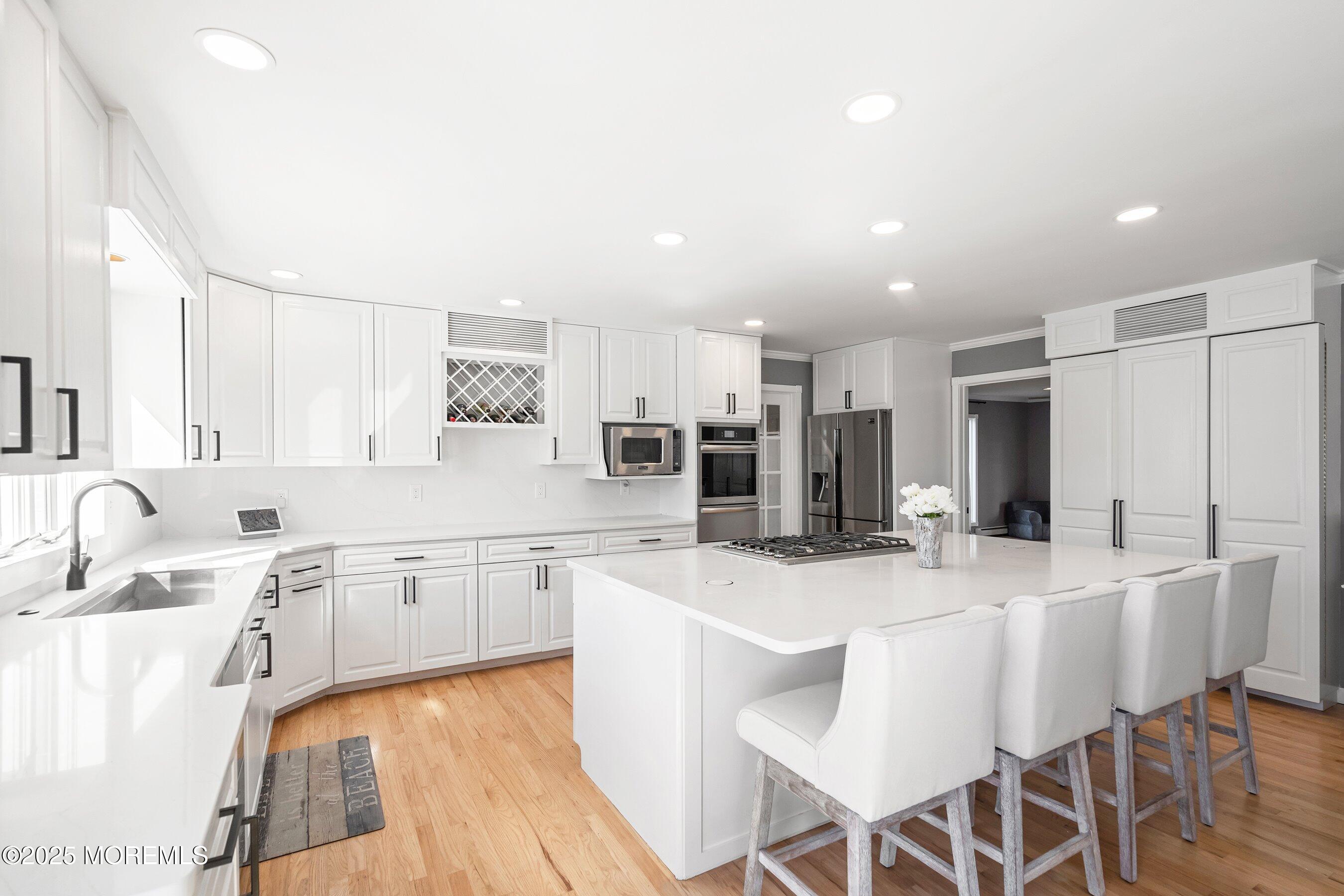 1615 Calamus Place Point Pleasant, NJ 08742 - Photo 15 of 62 a large kitchen with kitchen island a sink table and chairs
