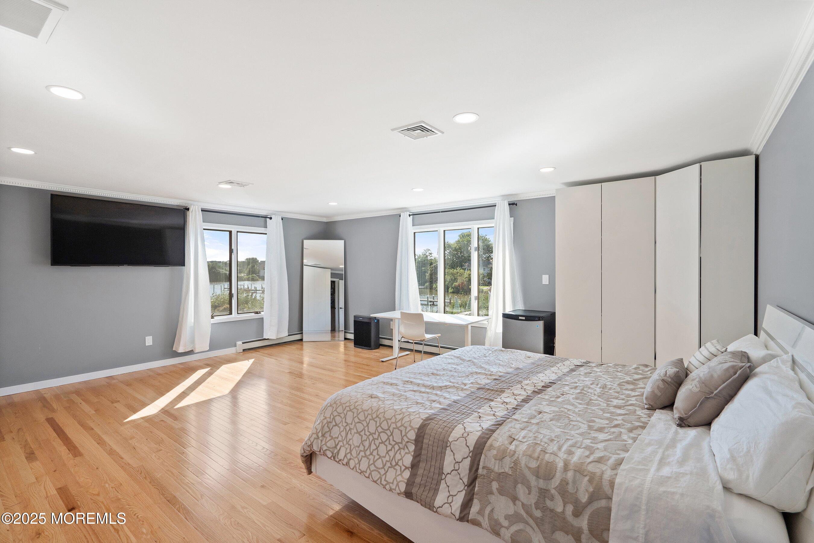 1615 Calamus Place Point Pleasant, NJ 08742 - Photo 30 of 62 a bedroom with a large bed and a flat tv screen on dresser