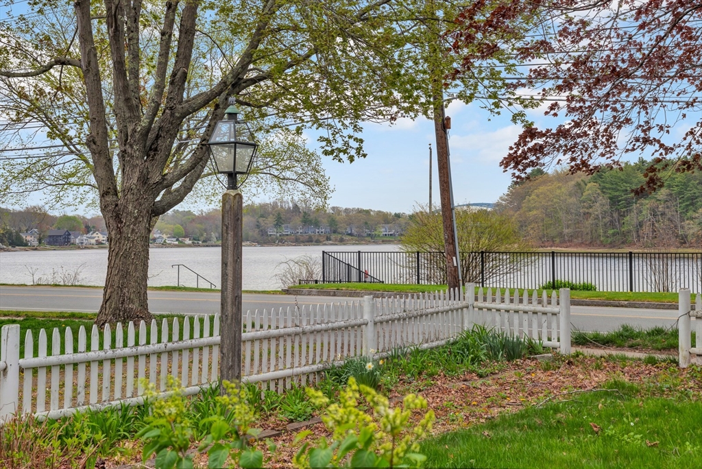 382 Main Street Amesbury, MA 01913 - Photo 13 of 42 a view of a deck with a fence and a large tree