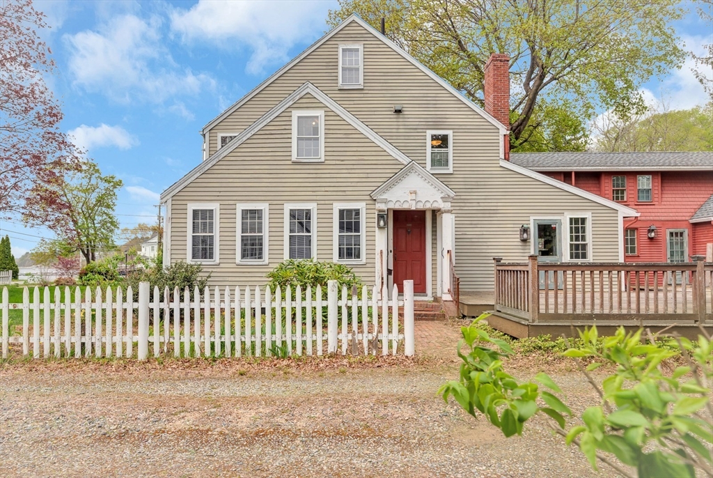 382 Main Street Amesbury, MA 01913 - Photo 2 of 42 a front view of a house with a garden