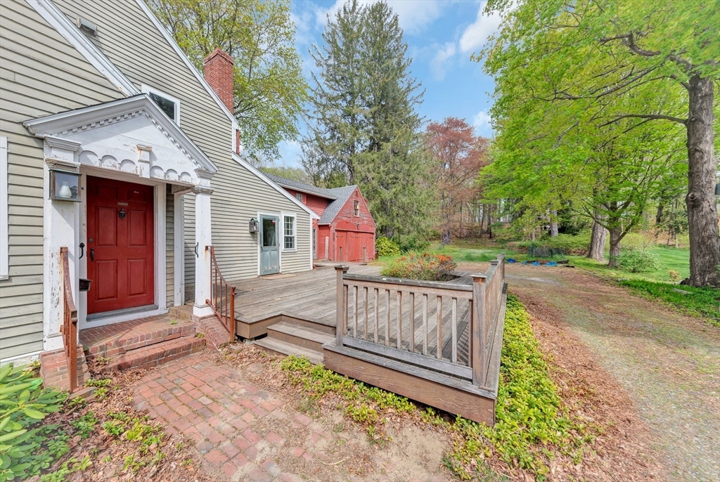382 Main Street Amesbury, MA 01913 - Photo 3 of 42 a view of a deck with a table and chairs and wooden fence