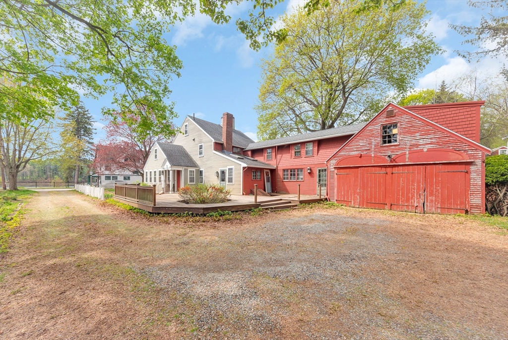 382 Main Street Amesbury, MA 01913 - Photo 6 of 42 a front view of a house with a yard and garage