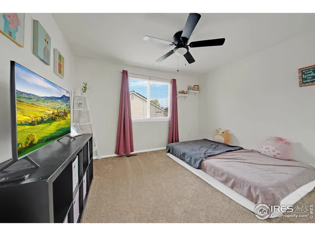 a bedroom with a bed and flat screen tv