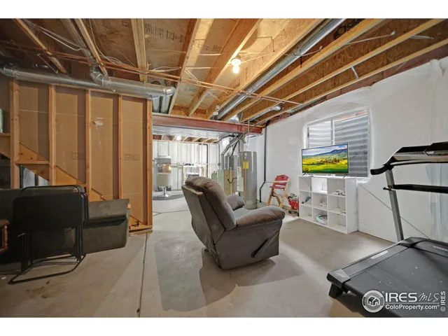 a living room with furniture and a painting on the wall