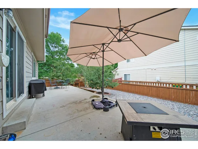 a backyard of a house with table and chairs