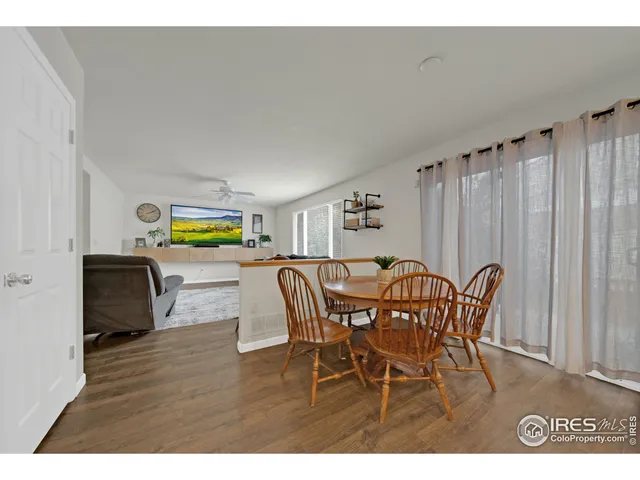 a dining room with furniture and a wooden floor