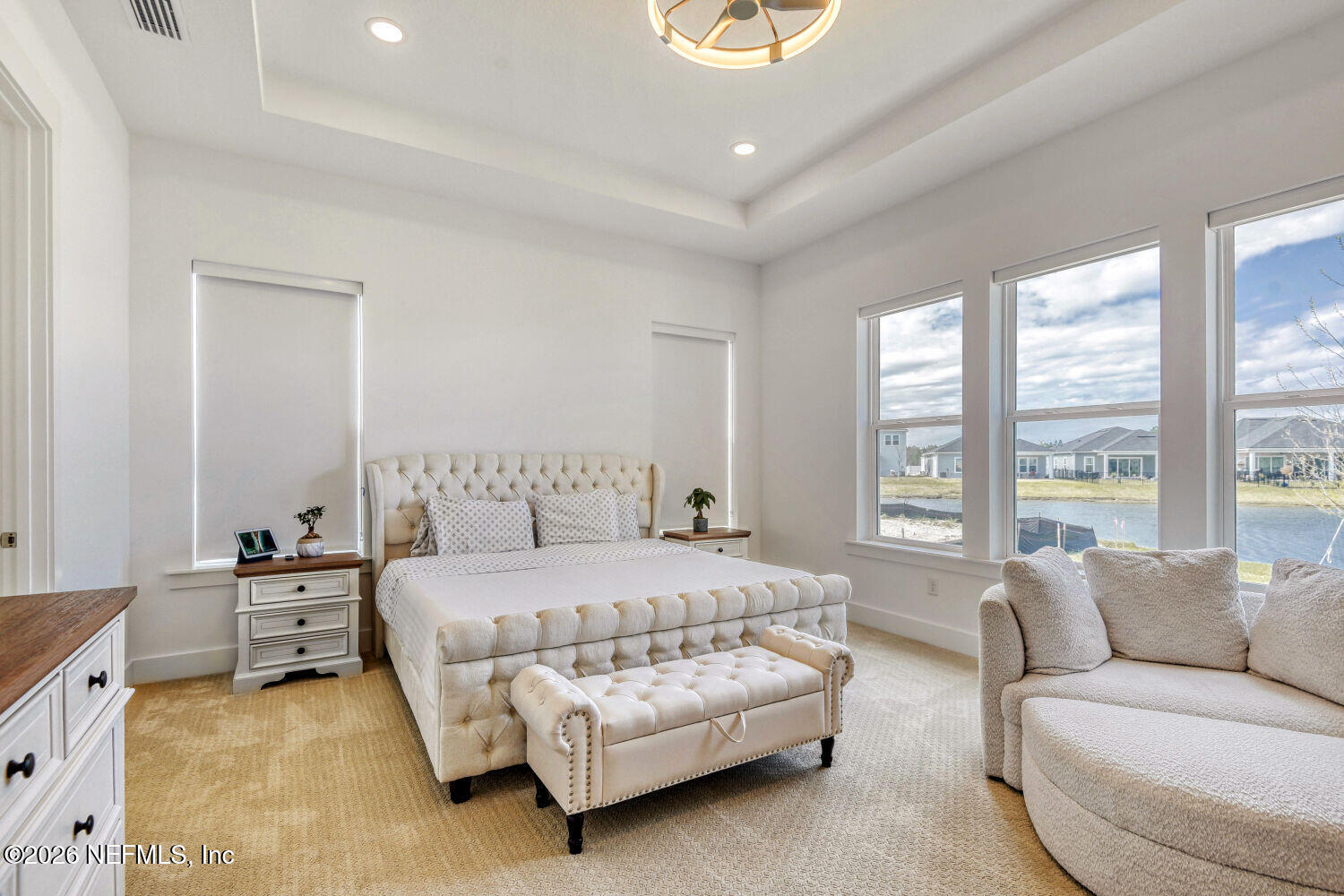 279 Bismarck Palm Road St. Augustine, FL 32092 - Photo 14 of 38 a bedroom with a bed couch and windows