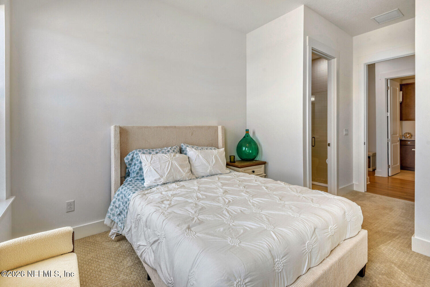 279 Bismarck Palm Road St. Augustine, FL 32092 - Photo 15 of 38 a large bed sitting in a bedroom next to a bathroom