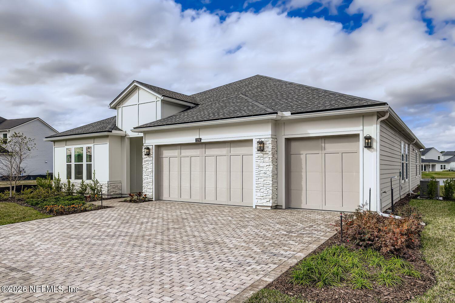 279 Bismarck Palm Road St. Augustine, FL 32092 - Photo 2 of 38 a front view of a house with a yard