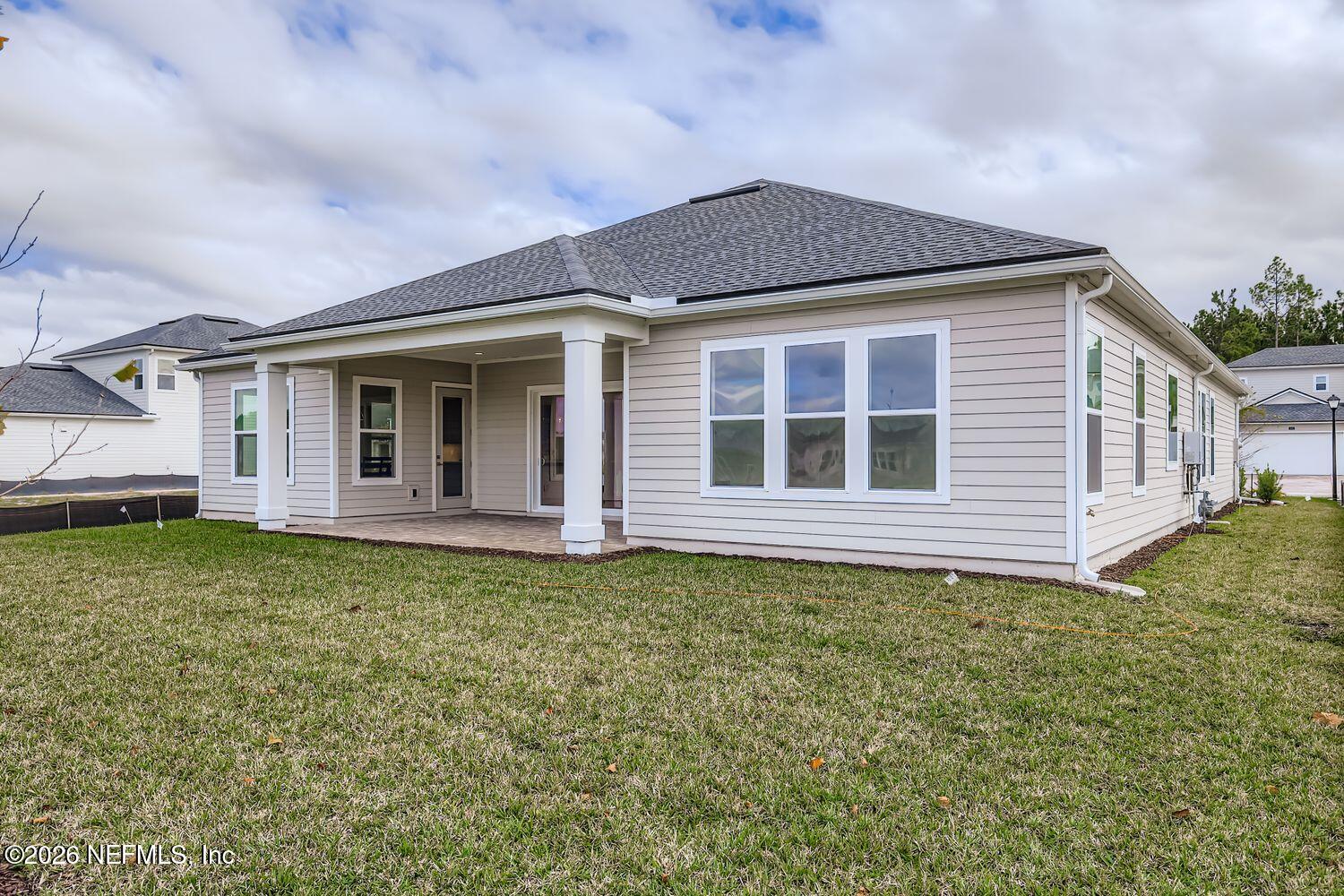 279 Bismarck Palm Road St. Augustine, FL 32092 - Photo 24 of 38 a front view of a house with a garden
