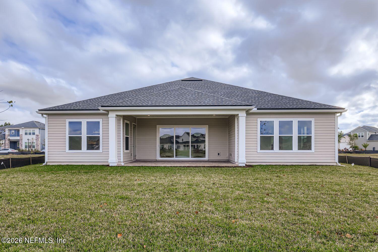 279 Bismarck Palm Road St. Augustine, FL 32092 - Photo 26 of 38 a front view of a house with a yard